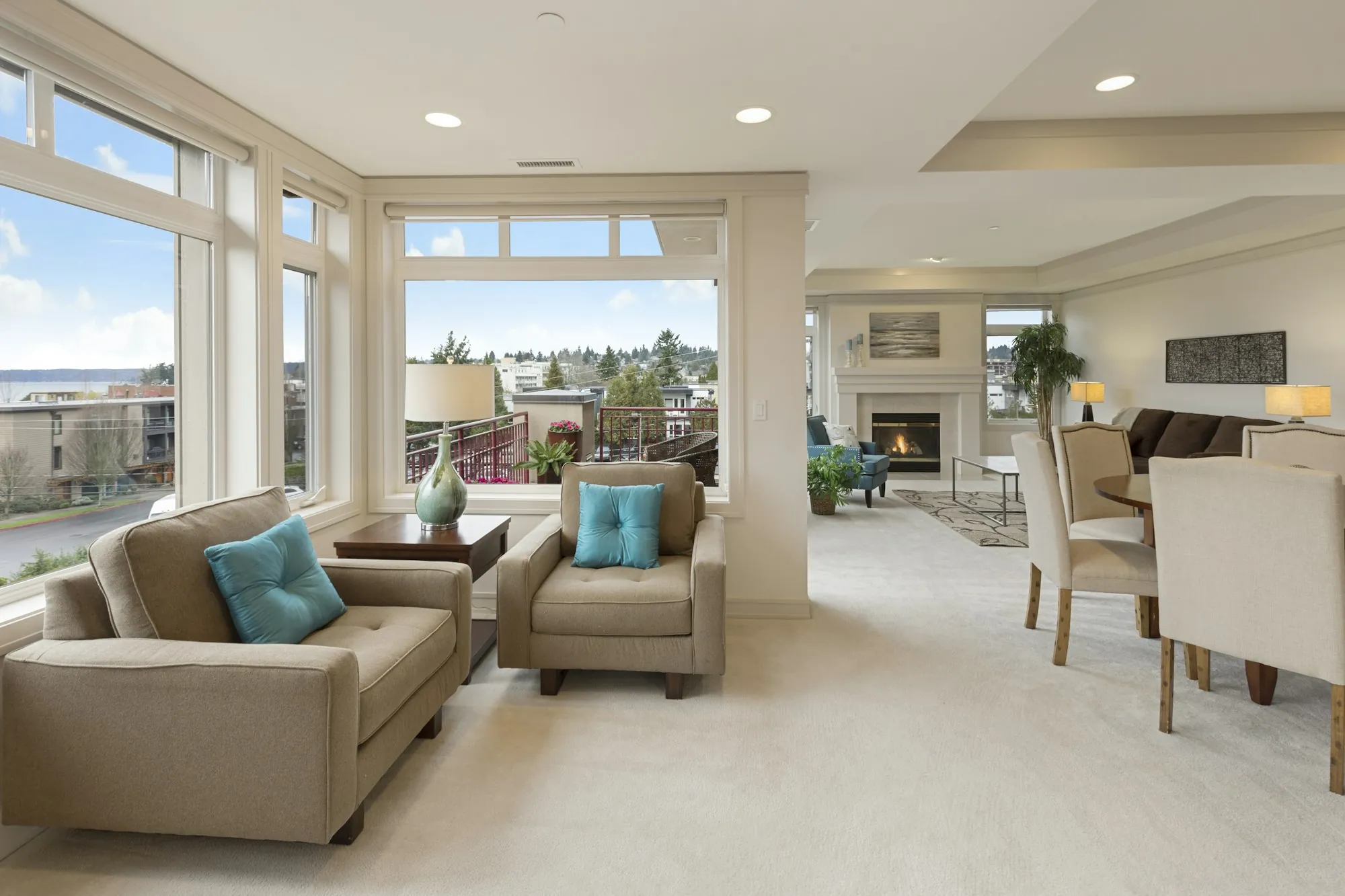 Living room with beige armchairs and large bright windows